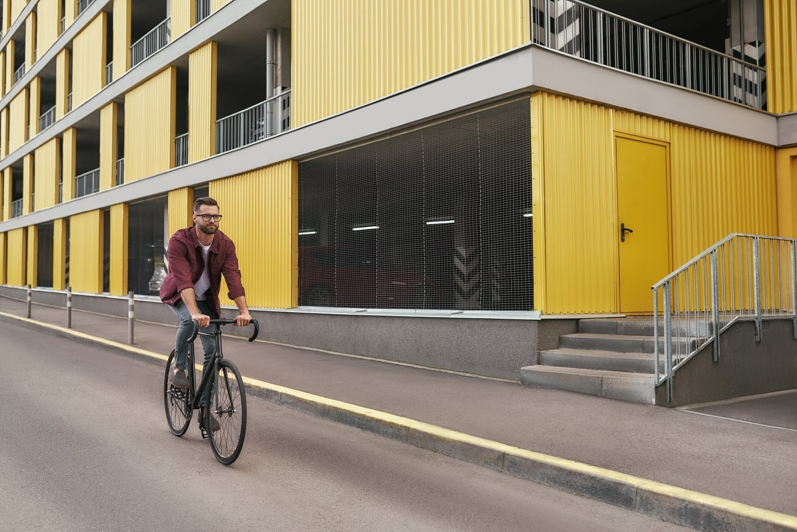 Cyclist riding past urban buildings